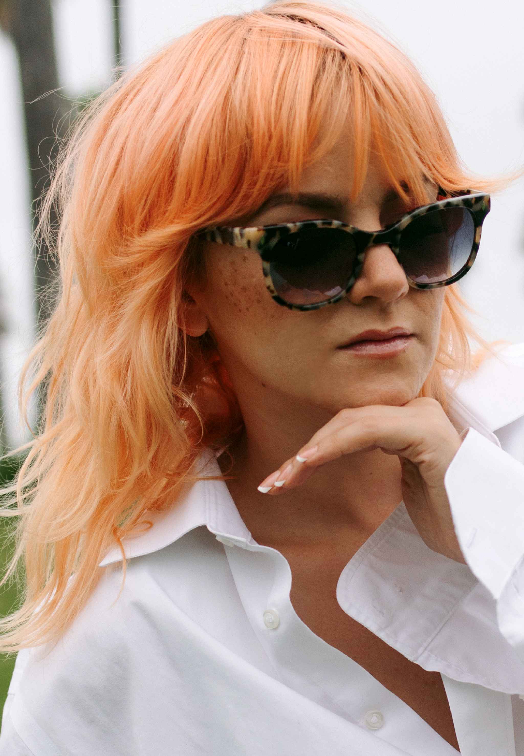 Crystal rose Billie sunglasses resting on a magazine